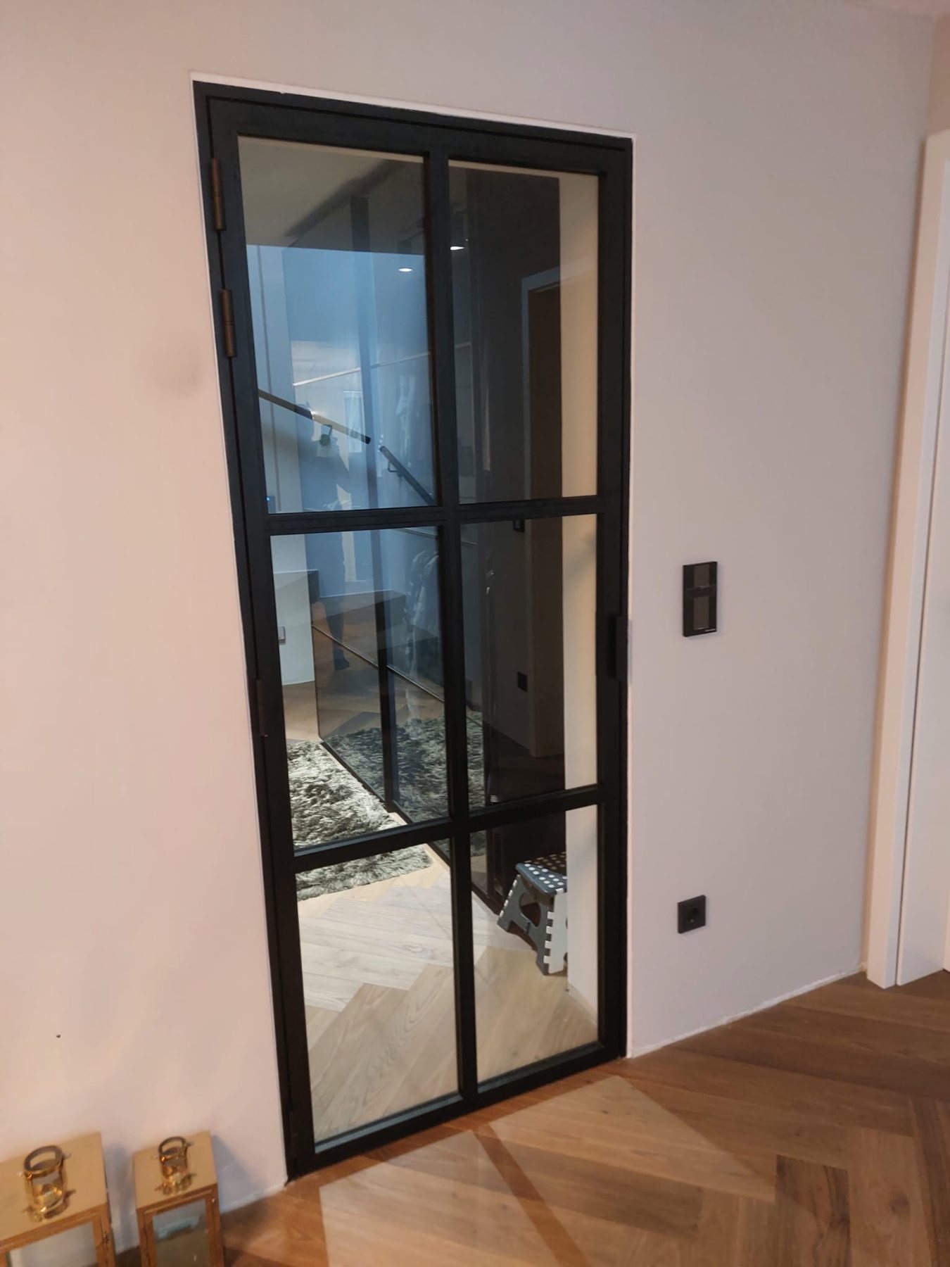 Schwarze Loftüre in Stahloptik mit sechsteiliger Sprossenteilung, Blick ins Treppenhaus