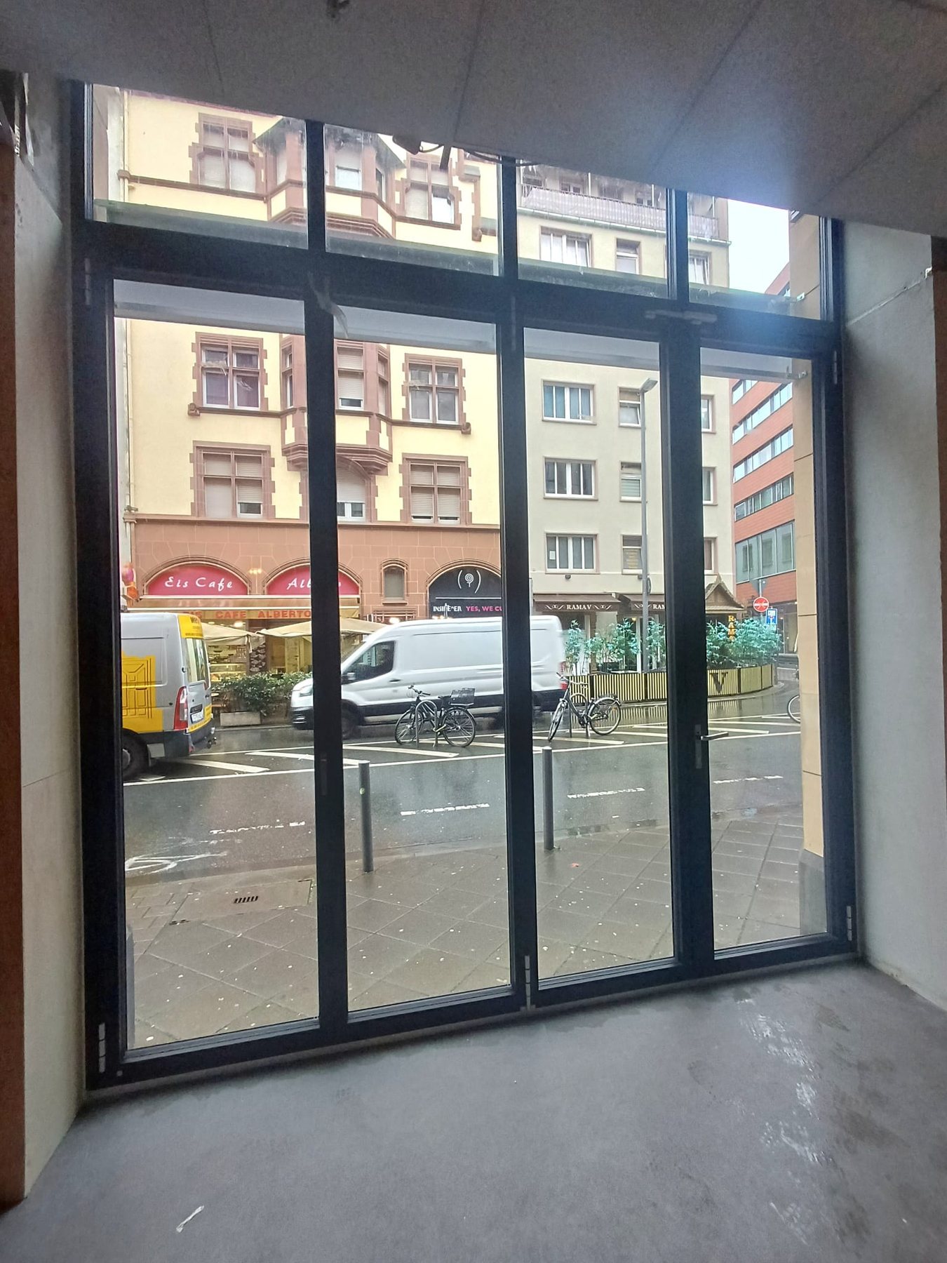 Geschlossene Glas-Faltanlage als Ladenfront, Blick von innen auf die Straße in der Frankfurter Innenstadt